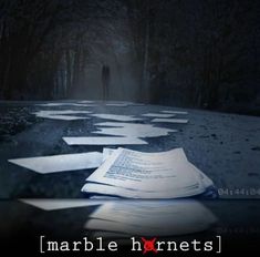 an open book sitting on top of a table in the middle of a dark forest