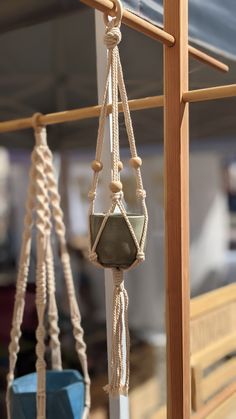 two hanging planters with ropes attached to them