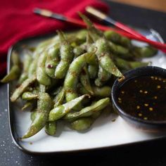 green beans on a plate with dipping sauce