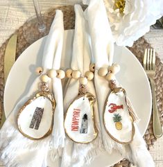 the place setting is decorated with white linens and gold accents, including napkins