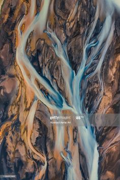 an aerial view of a river running through mountains and valleys in the distance, taken from space