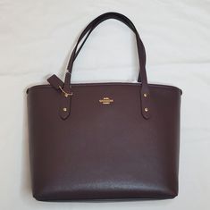 New Coach Mini City Zip Tote Oxblood New With Tags Color: Oxblood (Dark Purplish Brown) Approx. Measurements: 12in(L) X 8in(H) X 4in(W) Material: Crossgrain Leather Golden Tone Hardware Interior: Phone Pocket And A Multifunction Slip Pocket Zip Top Closure No Dust Bag Style: 10011161jax Feel Free To Ask Questions :) Coach Backpack Purse, Oxblood Color, Coach Parker, Mini City, Tan Leather Bag, Coach Leather Bag, Patent Leather Bag, Leather Handbags Crossbody, Coach Shoulder Bag