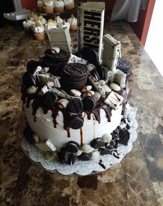 a cake with oreo cookies and chocolate frosting sitting on top of a table