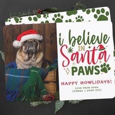 a pug dog wearing a santa hat sitting in a christmas card with paw prints