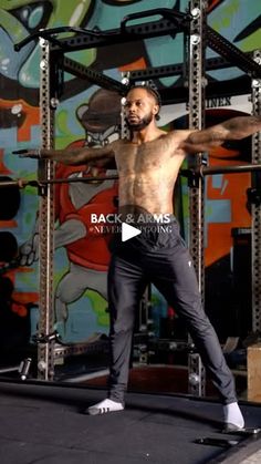 a shirtless man is standing on a skateboard in front of a colorful wall