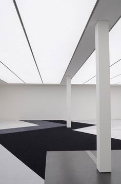 an empty room with black and white flooring