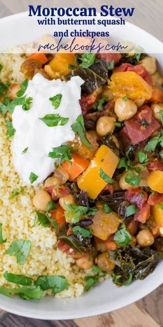 moroccan stew with butternut squash and chickpeas in a white bowl topped with sour cream