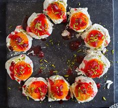 small appetizers are arranged in the shape of a circle on a black tray