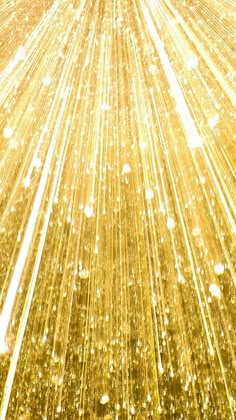 an aerial view of gold sparkles in the night sky with stars and lines on it