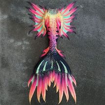 a colorful bird sculpture sitting on top of a cement floor next to a black wall