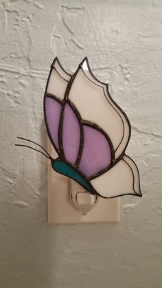 a stained glass flower is mounted on the wall