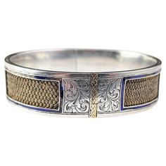 This unusual antique mourning bangle is so sweet and sentimental. It is an interesting and unusual design, the bangle designed in a typical aesthetic era manner in engraved sterling silver. It has inlaid 9ct gold sections and finely plaited light brown hairwork running through the centre and visible through the panels which have been highlighted with rich Cobalt blue enamel borders. It has an internal inscription to two sides, one side reads Kate to Bella and the other March 22nd 1870. A beautif Luxury Antique Silver Vintage Cuff Bracelet, Luxury Antique Etched Bangle, Luxury Vintage Etched Bangle, Aesthetic Era, Safety Chain, Bangle Designs, Unusual Design, Gold Enamel, So Sweet