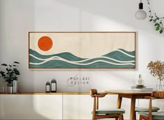 a painting hanging on the wall above a dining room table