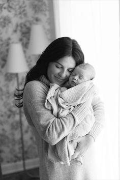 a woman holding a baby in her arms