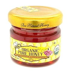 a jar of organic pure honey on a white background