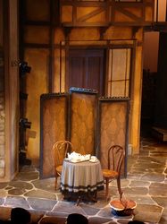 an empty stage with a table and chairs