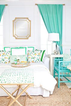 a bed room with a neatly made bed and green curtains