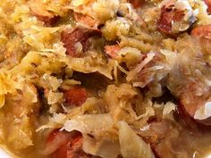 a close up view of some food in a bowl with onions and meat on it