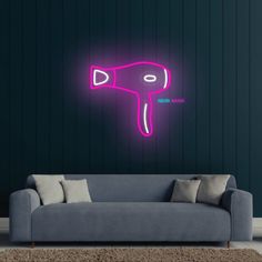 a neon pink hair dryer sitting on top of a couch next to a wall