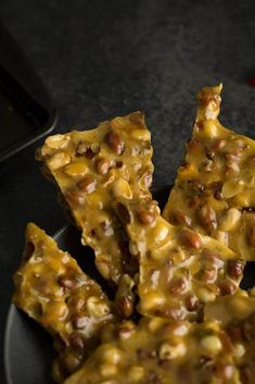 pieces of food on a plate with text overlay that reads jalapeno peanut brittle