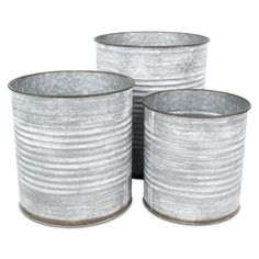 three silver tin canisters sitting next to each other