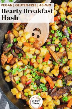 a skillet filled with vegetables and topped with a wooden spoon that says vegan gluen - free 45 min hearty breakfast hash