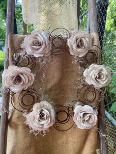 a chair with some flowers on it and a lace doily around the back of it