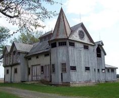 an old wooden house with a steeple on the roof