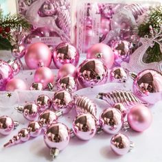 pink christmas ornaments and decorations on a table