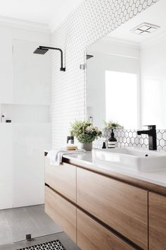 a bathroom with two sinks and a large mirror