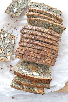 several slices of bread with nuts and seeds on top