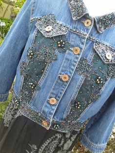 a denim jacket with sequins and buttons on it