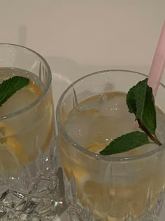 two glasses filled with lemonade and mint garnish