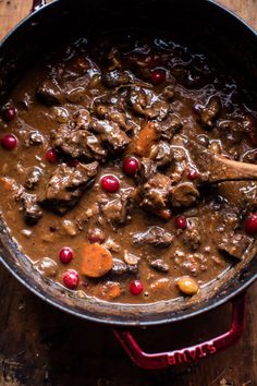 beef stew with cranberries in a red pot