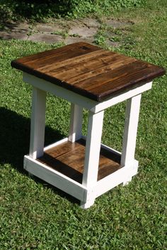 a small wooden table sitting in the grass