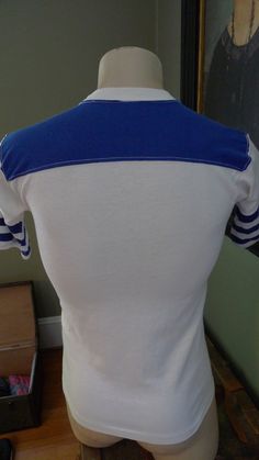 "All my pop t-shirts are vintage and in excellent shape. They may not be perfect but only with occasional minor flaws. All are very wearable and without significant flaws. Label: Sportwear, M Chest: 38 Inches Around (19\" Arm pit to arm pit) / Length: 27.5\" Any Item Can Be Returned For Any Reason Within 4 Days of Receipt We take product infringement seriously. Our items are vintage shirts we find at thrift stores, antique malls and estate sales. We do no manufacture shirts. If you think one of 1970s Shirts Women, Vintage Medium Wash Shirt With Button Closure, 1970s Style Fitted Button-up Shirt, 1970s Cotton Short Sleeve Tops, 1970s Fitted Cotton Shirt, Brothers Shirts, Pop T, Roller Girl, Antique Mall