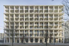 an apartment building with many windows and balconies