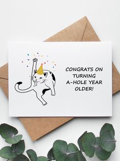 a card with an image of a cat wearing a party hat and confetti on its head