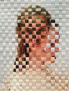 a woman's face is reflected in a mosaic tile wall with multiple images of her