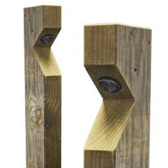 two wooden posts with speakers attached to them