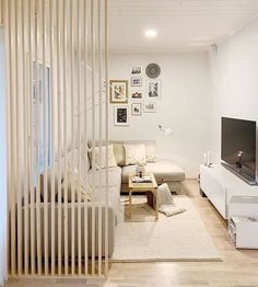 a living room with white walls and wooden slats