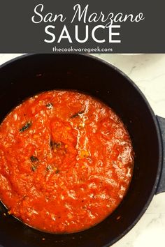 a skillet filled with sauce on top of a white counter