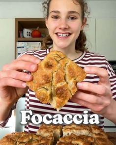 a girl holding up a piece of bread with the words focaccia in front of her