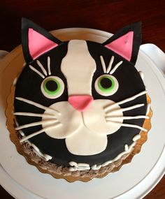 a black and white cat cake with green eyes