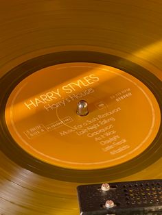 a yellow record with the words harry styles on it