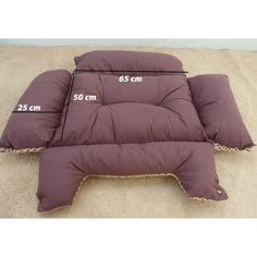 the measurements for a dog bed on top of a carpeted floor with two pillows