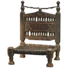 an old wooden bench with intricate carvings on it's back and seat, against a white background