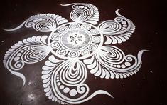 an intricately designed design on the floor is shown in white ink, with swirls and dots