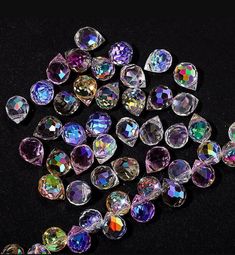 many different colored diamonds on a black surface