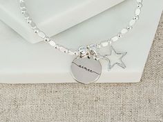 Personalised Star Stacking Bracelet with Engraved Name Charm Introducing our cute Star Bracelet, an elegant addition to our new range of stacking bracelets. Perfectly designed for those who adore a touch of charm, it stands out beautifully when worn solo, or you can pair it with other bracelets from our collection for a layered look. ☆ Product Details: * Material: Silver plated. * Bracelet Type: Beaded stretchy bracelet. * Charm: Silver plated star charm, with an engraved name disc charm. * Size: This stretchy bracelet comfortably fits most wrist sizes. * Gift Box: Considering gifting? Opt to add a gift box for that special touch. ☆ How to Order: * Choose whether to add a gift box from the dropdown box. * Personalise Your Bracelet: Write the initial you would like in the personalisation bo Silver Star Bracelet For Friendship, Silver Friendship Bracelets With Star Charm, Silver Bracelet With Star Charm For Friendship, Silver Bracelets With Star Charm For Friendship, Silver Beaded Bracelets With Star Charm As Gift, Silver Beaded Bracelet With Star Charm For Gift, Silver Beaded Bracelet With Star Charm As Gift, Jewelry Star, Stacking Bracelets